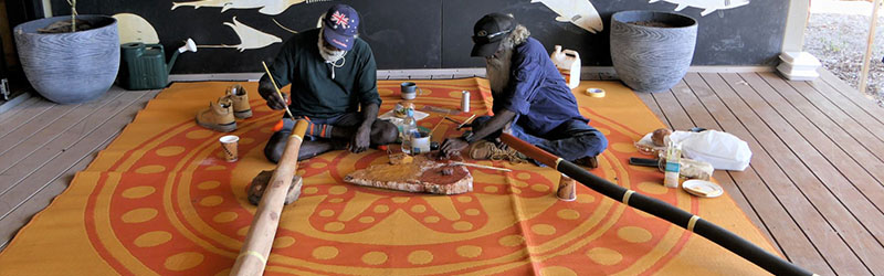 Painting the yidaki (didgeridoo) at Anindilyakwa Arts Centre Groote Eylandt